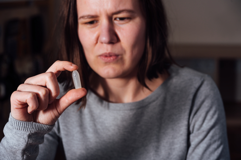 Woman looking at a suppository